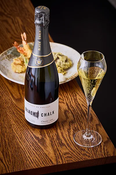 Black Chalk sparkling wine with a glass
