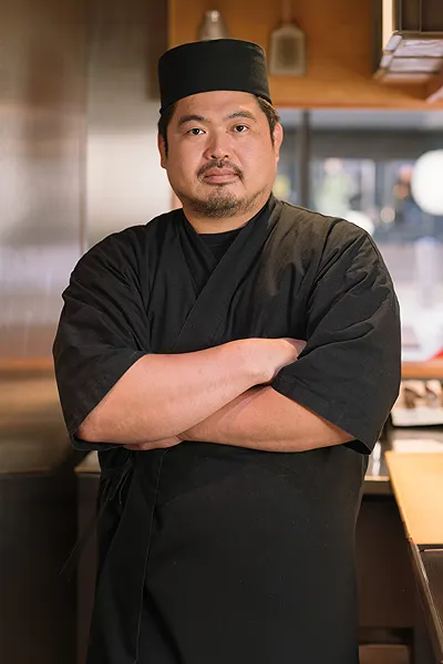 Owner Chef Takamasa Mogi standing at omakase suchi counter